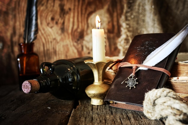 Diary and feather with a bottle of rum