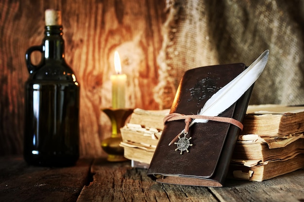 Diary and feather with a bottle of rum