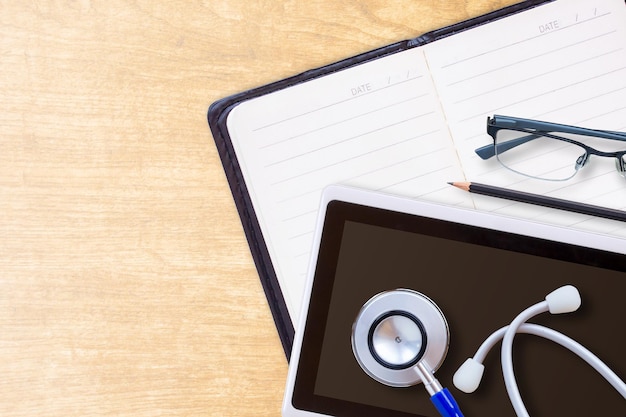 Photo diary planner book in black leather and stethoscope