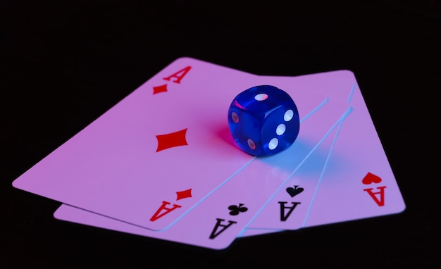 Dice and four aces on a black background with blue-red neon light