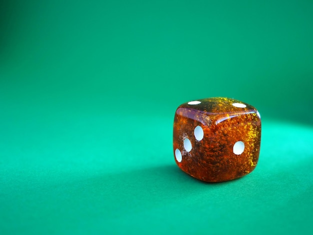 Photo dice from amber on a green background