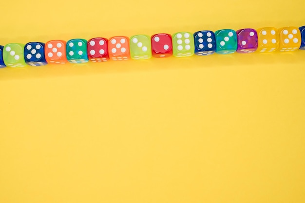 Dice in a row isolated on a yellow background