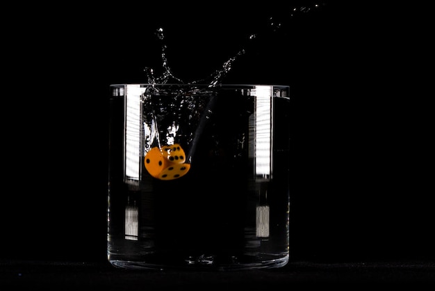 Dice in water splash on black background