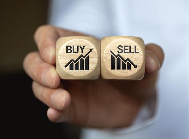 Dices cubes with the words SELL BUY on financial downtrend chart graph Selective focus