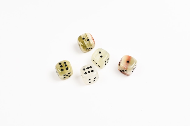 Dices made of natural stone on a white background. Copy space. Gaming.