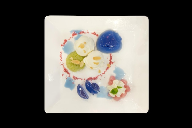 Die cut of Thai Red Ruby in Coconut Milk with whipped cream on black isolated