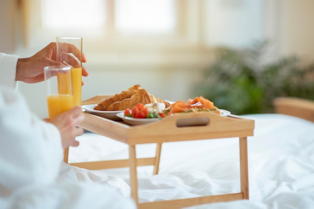 Dienblad met ontbijt op bed voor paar bij hotelclose-up