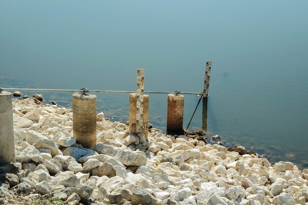 Foto dieptemarkering op rotsen aan de oever van het meer