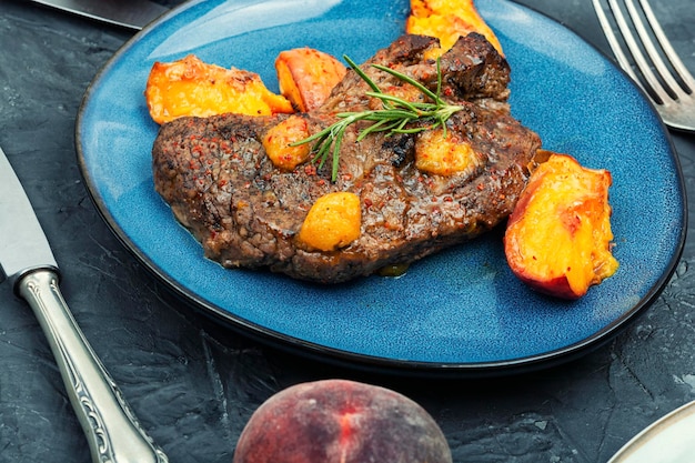 Diet baked beef steak with peach