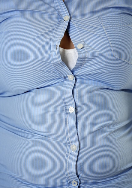diet concept overweight woman in tight shirt closeup