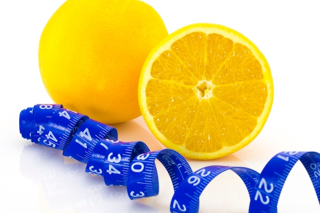 Diet concept Ripe Orange and measuring tape isolated on white background