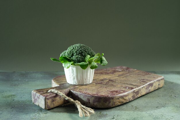 Diet cupcake from broccoli and corn salad on wooden board