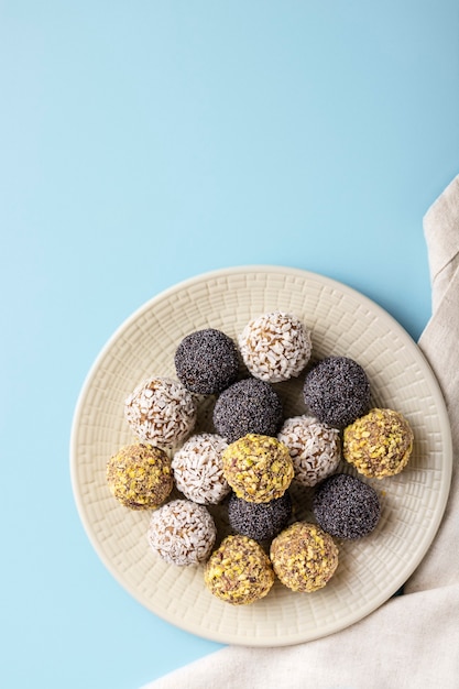 Diet energy balls lie on large plate on blue