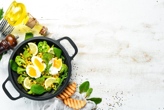 Diet food Boiled vegetables and boiled egg in a frying pan Rustic style Top view Free space for your text