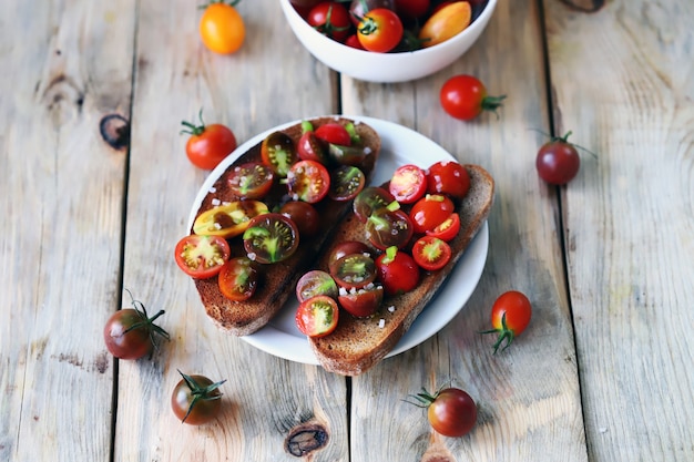 Diet food with mini tomatoes on toasts