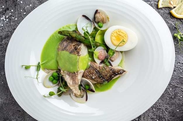 Diet food zander fillet served with fresh salad, pike perch fish fillet with mussels, peas, asparagus and vegetable cream sauce, Restaurant menu, dieting, cookbook recipe,