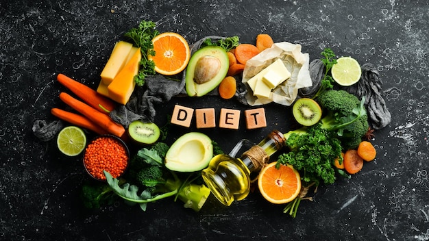 Photo diet inscription avocado carrot orange broccoli dried fruits nuts and parsley top view free space for your text