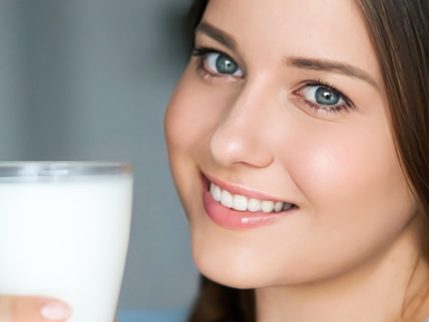 Diet and wellness young woman with glass of milk or protein shake cocktail