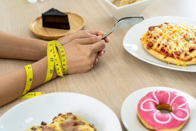 Diet Women do not eat sweets and fats The tape measure is placed around the arm for weight loss