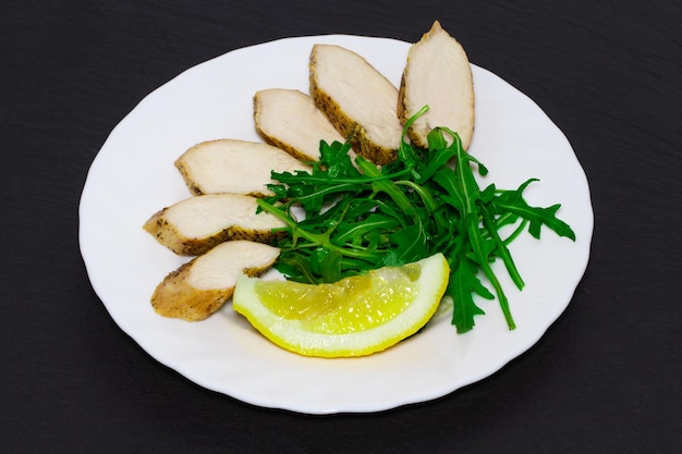 Dietary cuisine - Grilled chicken breast with rucola leaves.