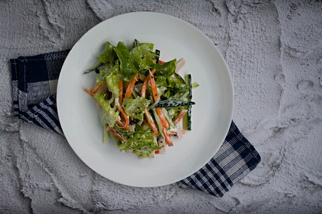 Dietary food, fresh vegetable salad with imitation of crab stick, seasoned with soy sauce and Japanese sesame