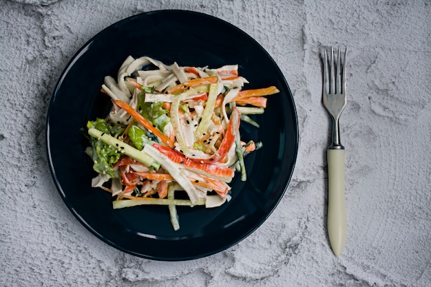 Dietary food, fresh vegetable salad with imitation of crab stick