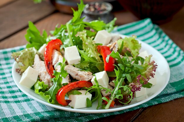 Photo dietary salad with chicken, arugula and sweet red pepper