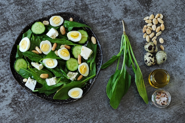 Dietary salad with spinach, quail eggs and nuts.