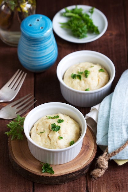 Dietary souffle of minced meat with parsley on a dark background.