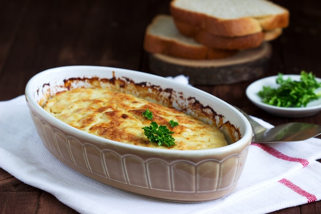 Dietary souffle of minced meat with parsley on a dark background.