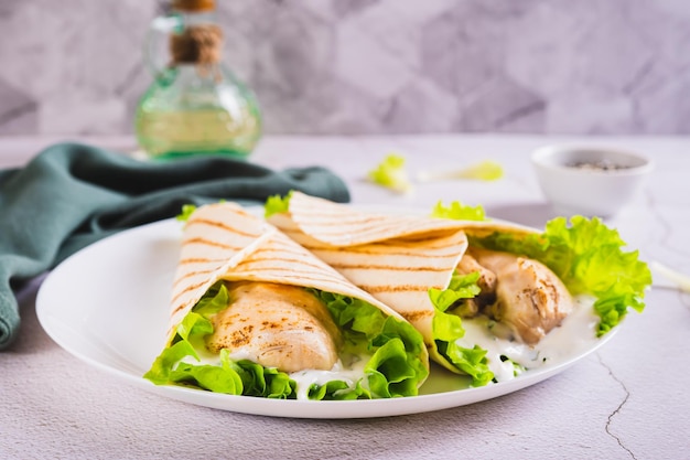 Foto dietische gegrilde taco's met kippenfilet sla op een bord op tafel