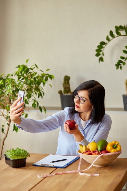 Dietitian woman recording on a smart phone her vlog about healthy eating