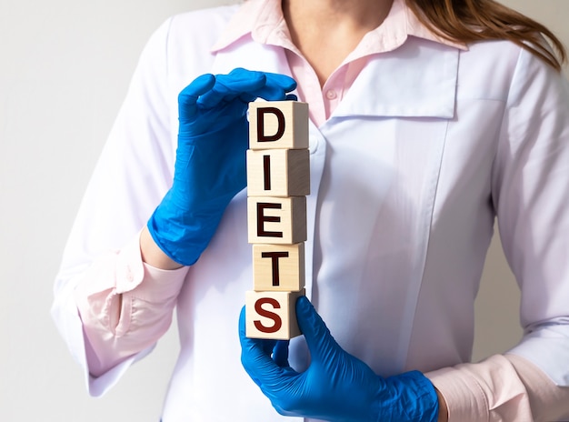 Diets word in doctor hands, dieting concept.