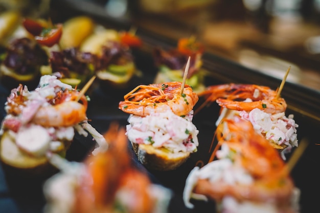 Different assorted canapes of bread with crab ham and vegetables