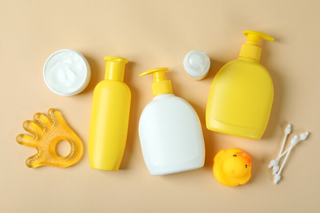 Different baby hygiene accessories on beige background