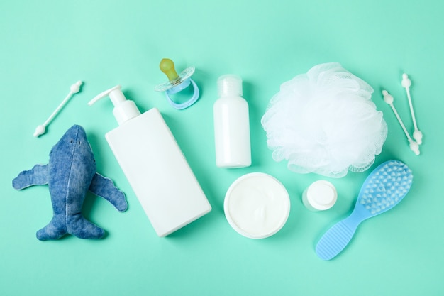 Different baby hygiene accessories on mint