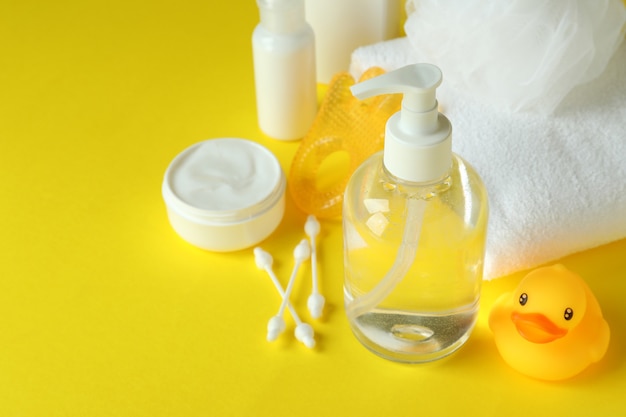 Different baby hygiene accessories on yellow background