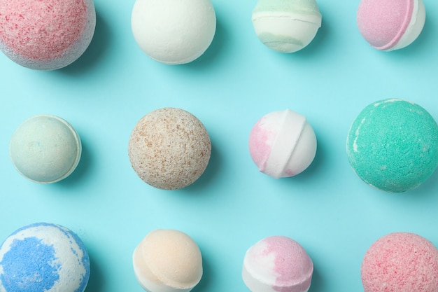 Different bath balls on blue background, top view