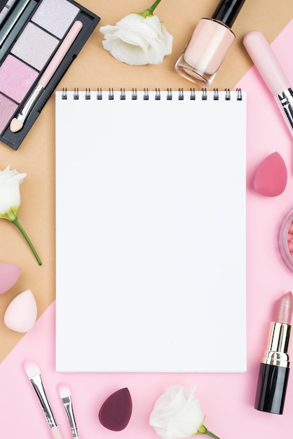 Photo different beauty products arrangement with empty notepad