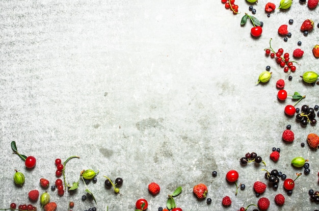 Different berries on the old stone table.