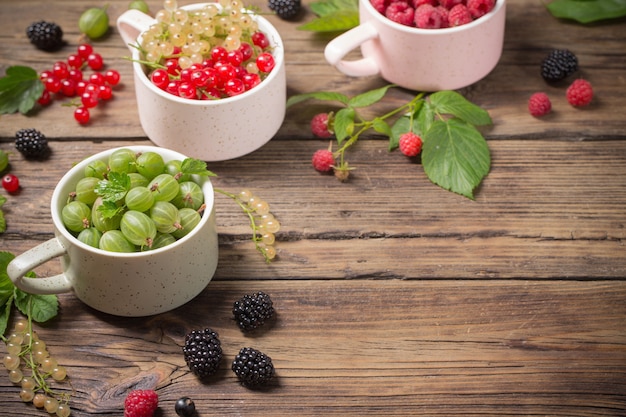 Photo different berries on old wooden