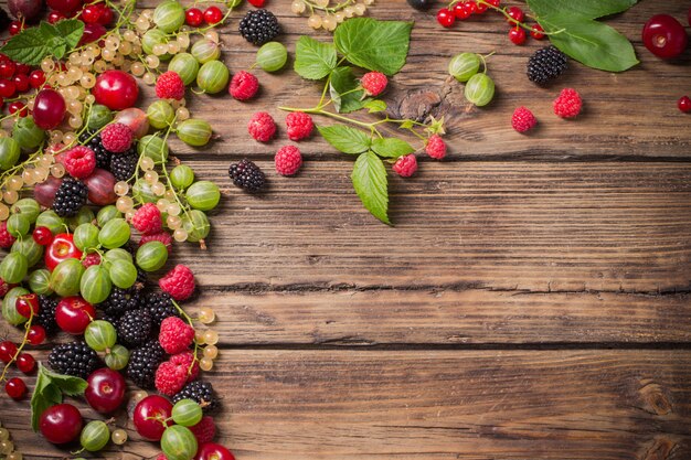 Different berries on old wooden