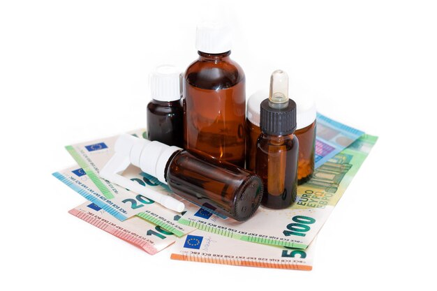 Different bottles with pills capsules and medicines on the euro banknotes