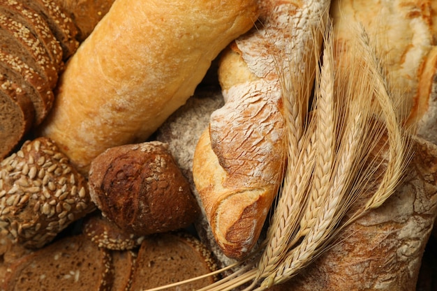 Different bread and spikelets on whole background, close up