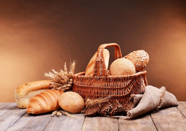 Different bread on table on brown background