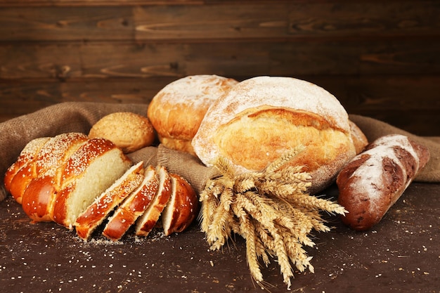 Разный хлеб с ушами на деревянном фоне