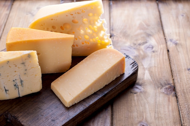 different cheese classic choice, on an old wooden board