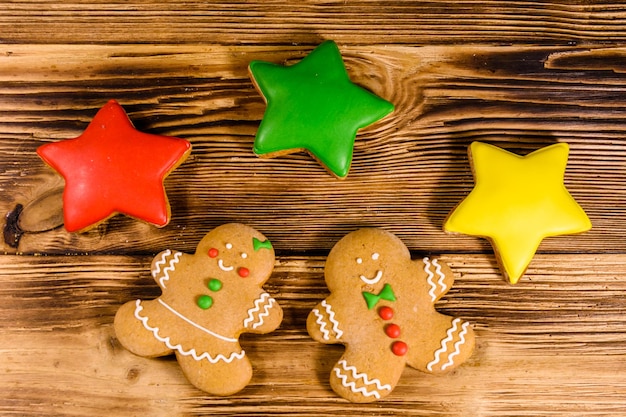 Different christmas gingerbread cookies on rustic wooden table. Top view