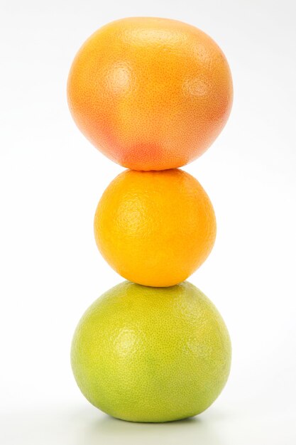 Different citrus fruits on white table