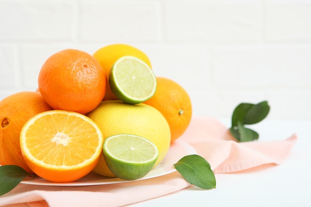 Different citrus and juicy slices on a colored background place to insert text